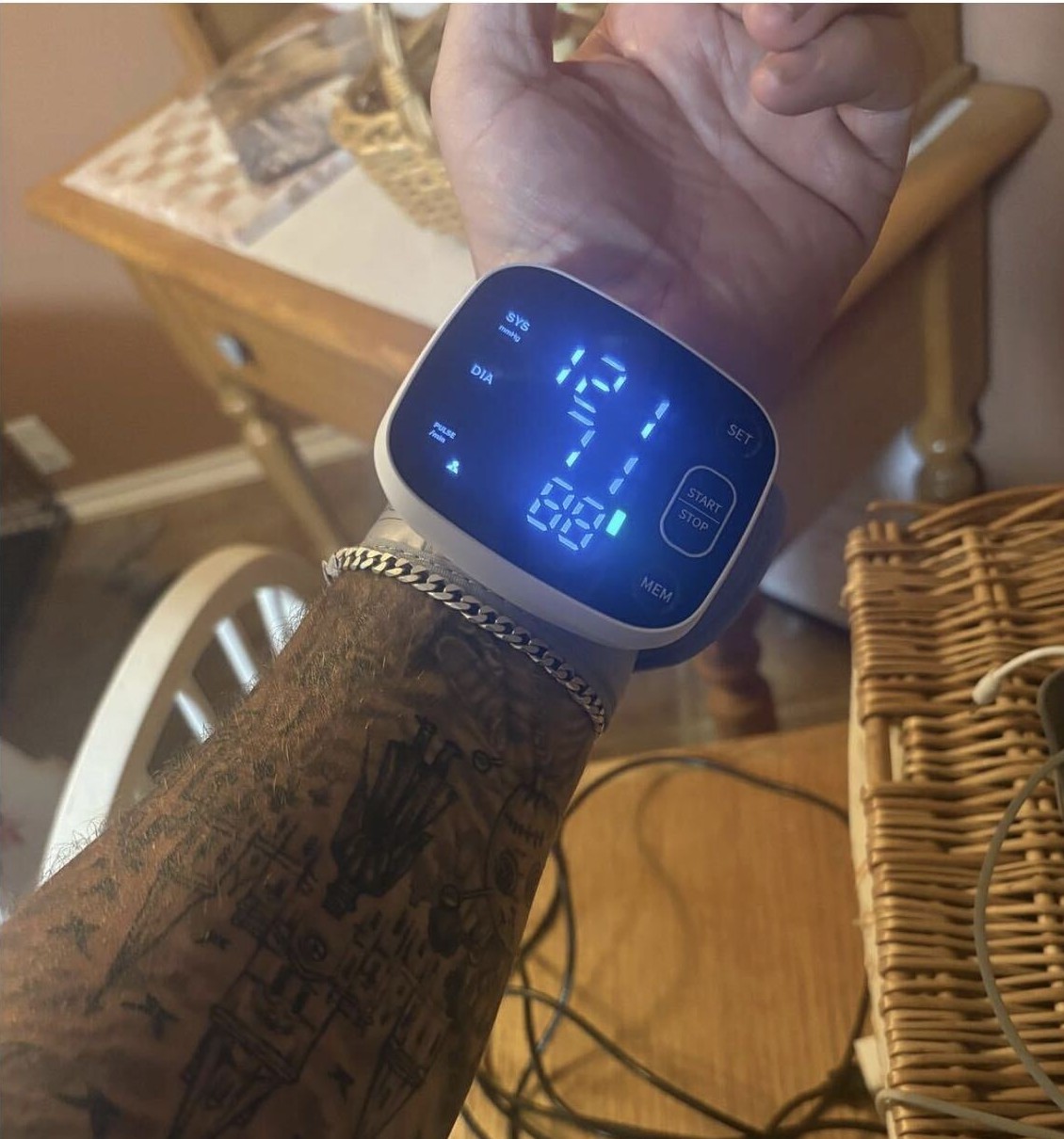 Member checking his blood pressure with a wrist monitor